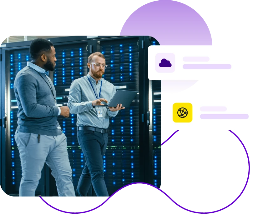 Two people in server room with a laptop