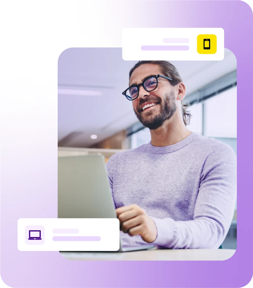 Smiling man with laptop on desk