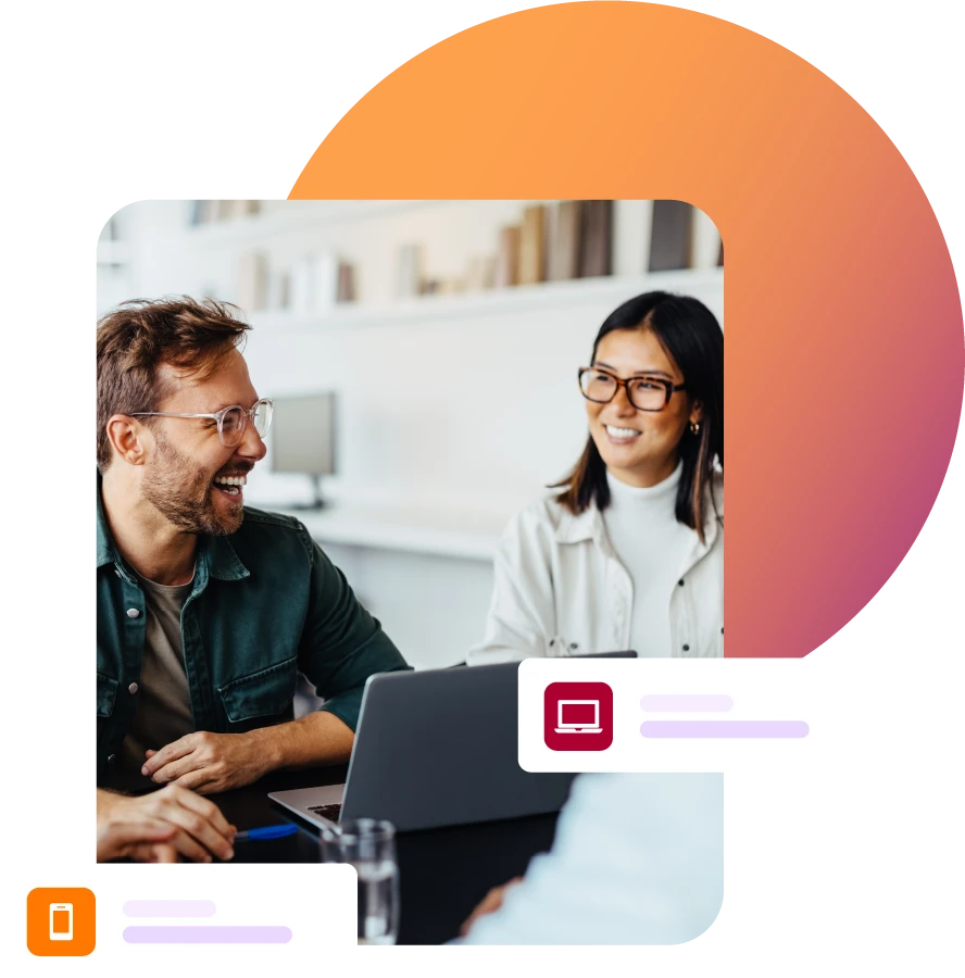 Man and lady smiling during a meeting with laptop on table