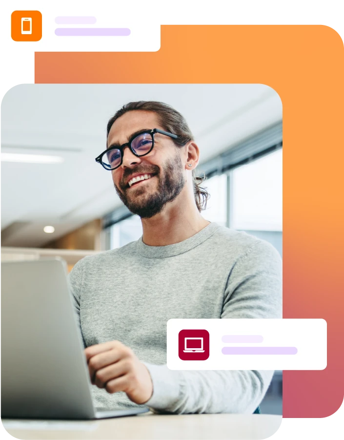 Smiling man with laptop on desk