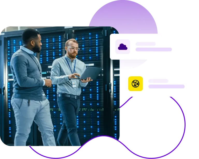 Two people in server room with a laptop